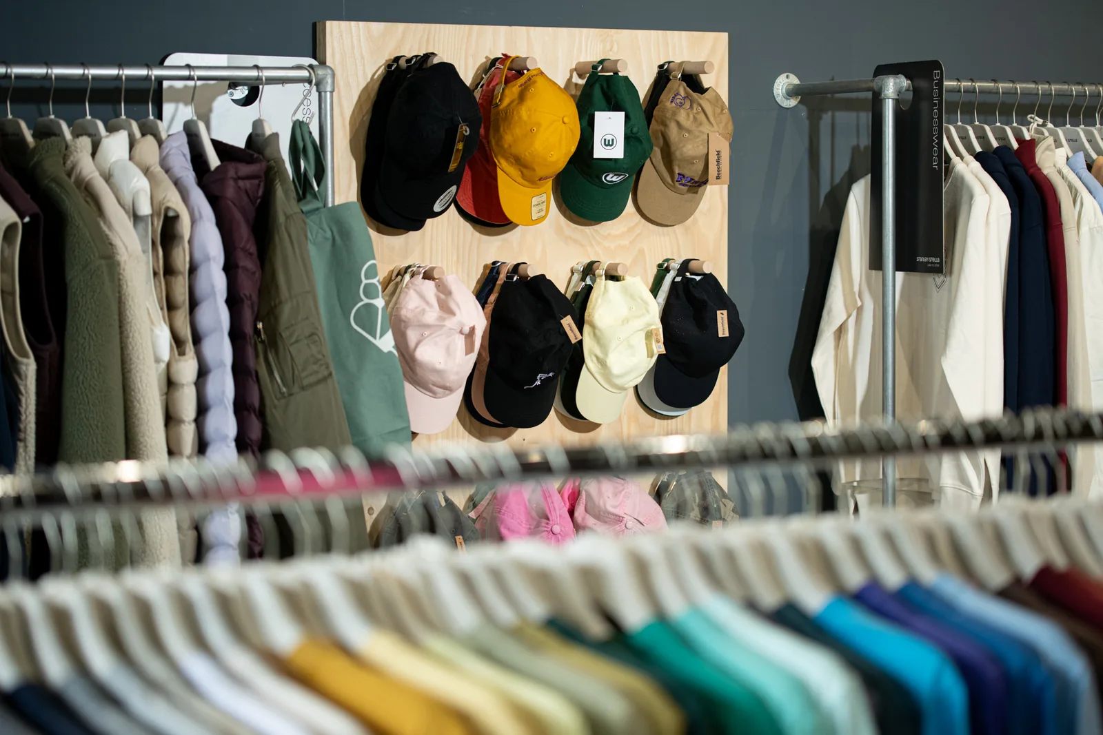 Caps and garments in the TIME/LESS Prints showroom.